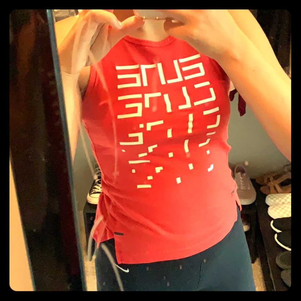 Red Nike shirt with white design on the front